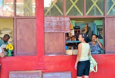 A lady shops at a bodega in havana, cuba.