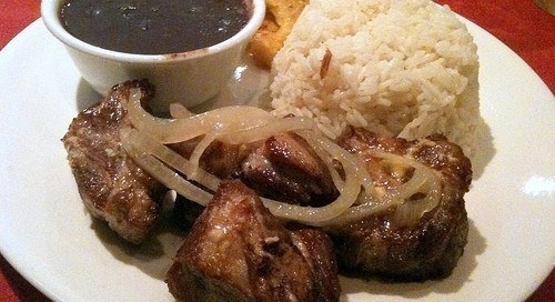 Authentic Cuban oferta meal. Pork and rice with beans and yuca.