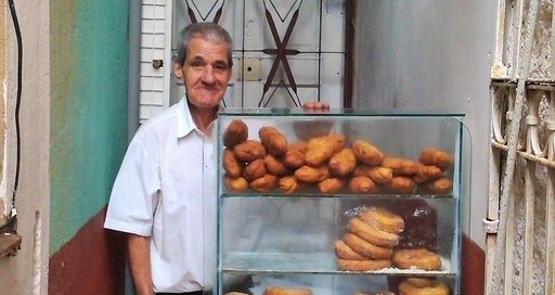 This is Miguel. He is an independent business owner in Vedado, Havana. He has set up shop, beside a school, and sells fried snacks to students. His prices are very low. Most of his products only cost 1 or 2 pesos (moneda nacional). Nevertheless, he is able to earn a salary which is well above average. Considering that he sells about 150 items per day, we can estimate that his daily revenue is about 10 CUC. That translates to a yearly revenue of over 2500 CUC. At a 50% profit margin, he is able to take home over 1000 CUC, after taxes. Miguel is a shining example of the opportunity for small business in Cuba. He works hard, but he is happy. He is almost 90 years old, but he still loves to get up every morning and work for himself and provide for his family. He is proud.