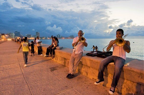 Men playing music and a party on Malecon Havana, Cuba